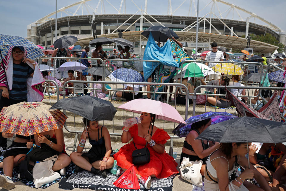 Image: People holding umbrellas wait for the Taylor Swift concert, in Rio de Janeiro (Pilar Olivares / Reuters via Redux)