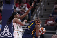 New York Liberty forward Jonquel Jones tries to block a shot by Indiana Fever forward Aliyah Boston (7) in the first half of a WNBA basketball game, Thursday, May 16, 2024, in Indianapolis. (AP Photo/Michael Conroy)