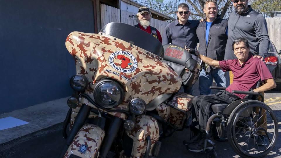 Veterans of the Battle of Mogadishu, Somalia, pose with a specially commissioned Harley Davidson Motorcycle, named 
