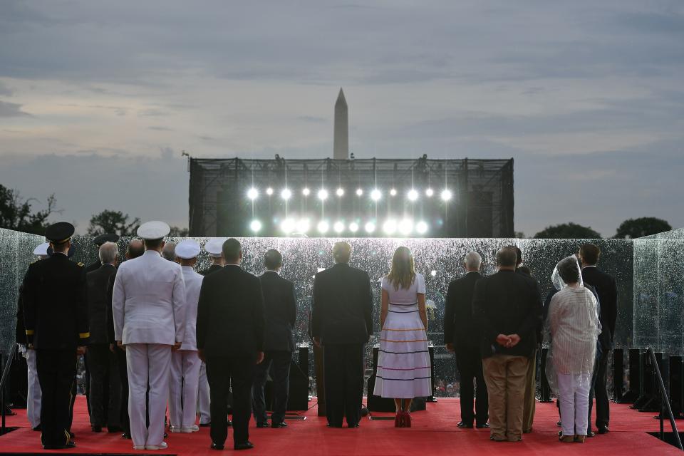 US President Donald Trump (C-L) and First Lady Melania Trump stand onstage with others during the "Salute to America" Fourth of July event at the Lincoln Memorial in Washington, DC, July 4, 2019. (Photo by MANDEL NGAN / AFP)        (Photo credit should read MANDEL NGAN/AFP/Getty Images)