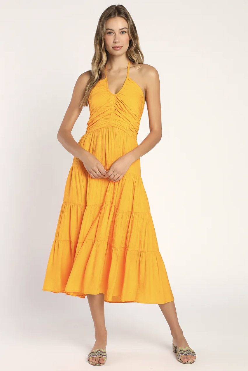 blonde model wearing canary yellow sun dress, Chasing Sun Marigold Tiered Keyhole Halter Midi Dress (Photo via Lulus)