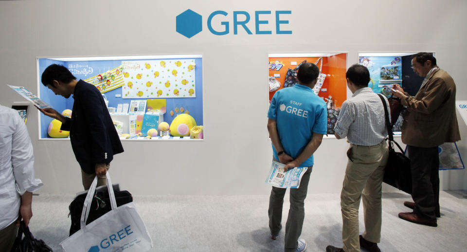 People visit the booth of GREE Inc. , a growing social gaming service, at the Tokyo Game Show in Makuhari, Chiba, near Tokyo,Thursday, Sept. 20, 2012. Some 200 companies take part in the annual gala exhibition which opens to the public on Sept. 22-23. (AP Photo/Koji Sasahara)