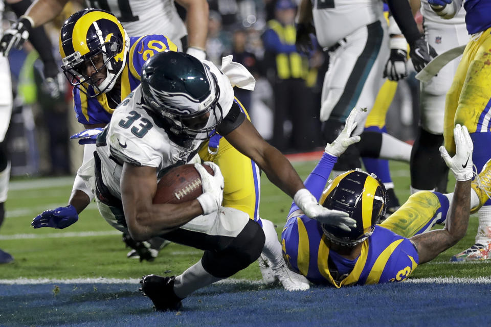 Philadelphia Eagles running back Josh Adams scores past Los Angeles Rams free safety Lamarcus Joyner during the first half in an NFL football game Sunday, Dec. 16, 2018, in Los Angeles. (AP Photo/Marcio Jose Sanchez)