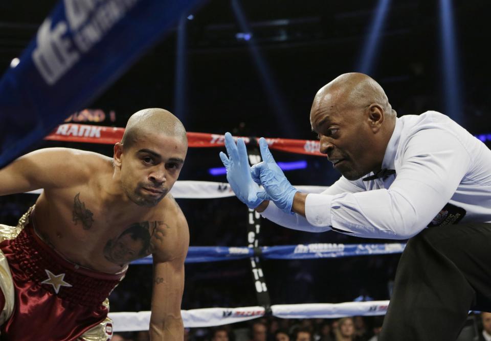 The referee counts after Wilfredo Vazquez, of Puerto Rico, after he was knocked down by Marvin Sonsona, of the Philippines, during the first round of a NABF Featherweight Title boxing match Saturday, June 7, 2014, in New York. Sonsona won the fight. (AP Photo/Frank Franklin II)