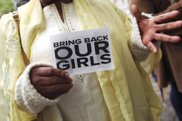 <p>Dan Kitwood/Getty Images</p> A woman holds a sign that reads 'Bring back our girls' during a protest outside Nigeria House