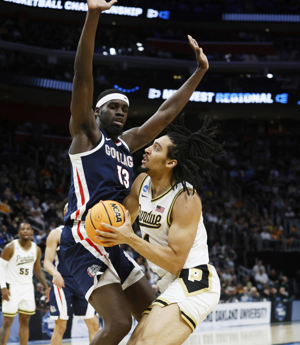 Purdue forward Trey Kaufman-Renn (4) is defended b Gonzaga forward Graham Ike (13) during the first half of a Sweet 16 college basketball game in the NCAA Tournament, Friday, March 29, 2024, in Detroit. (AP Photo/Duane Burleson)