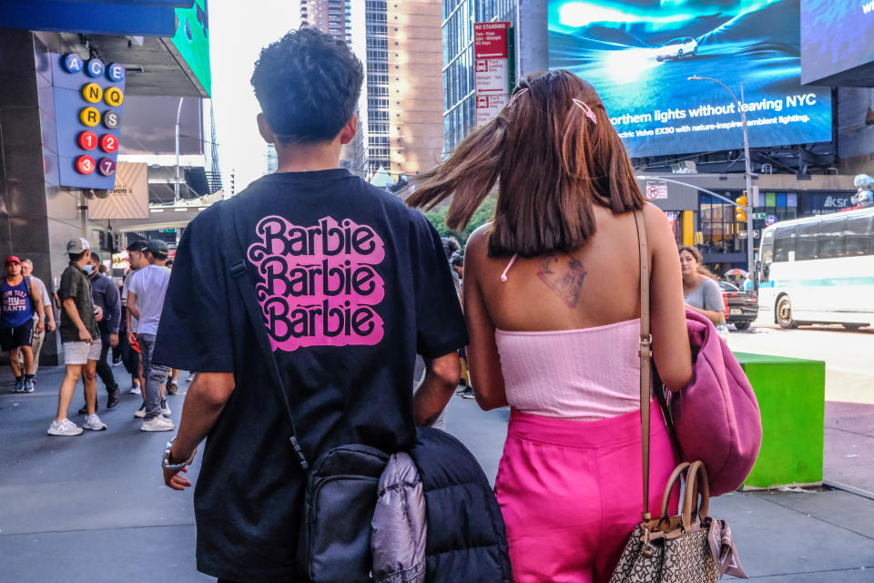 NEW YORK, NEW YORK - JULY 21: People dress up as the doll Barbie to attend the Barbie movie on July 21, 2023 in New York City.  On the opening day, director Greta Gerwig's film 