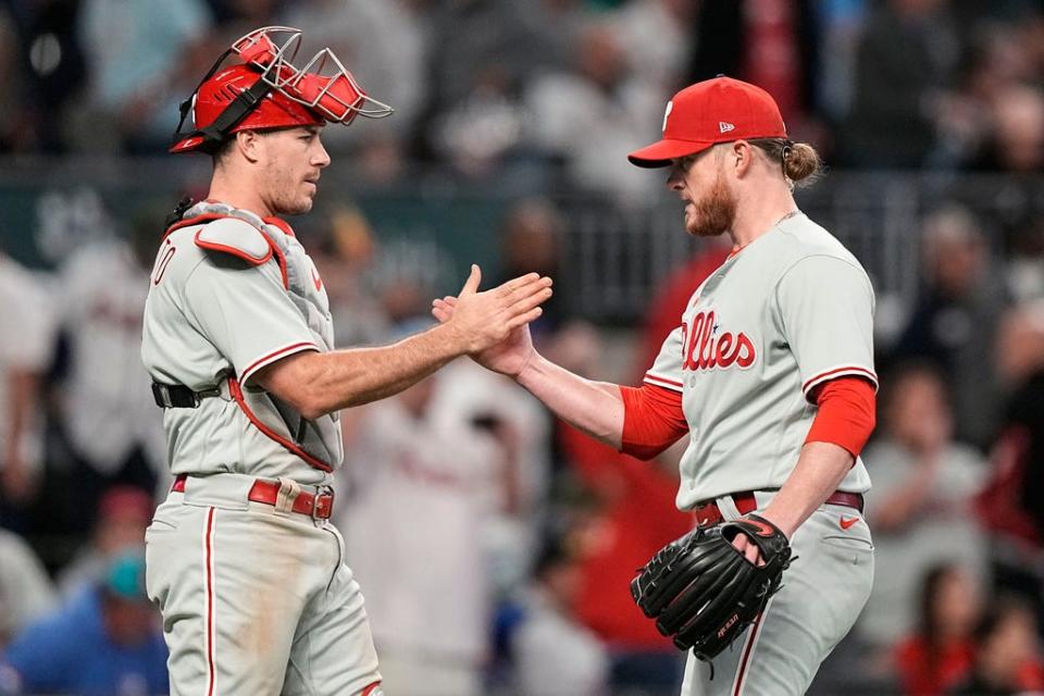 Philadelphia Phillies closer Craig Kimbrel, right, speaks with Philadelphia Phillies catcher J.T. Realmuto after Game 1 of a baseball NL Division Series, Saturday, Oct. 7, 2023, in Atlanta. The Philadelphia Phillies won 3-0. (AP Photo/Brynn Anderson)