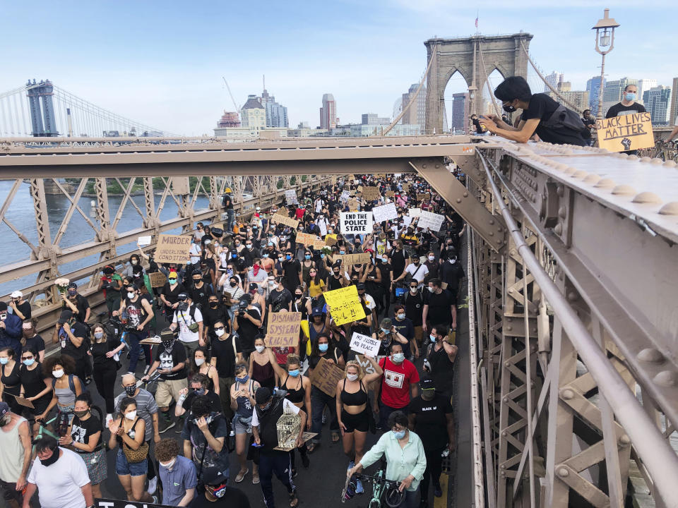 Demonstrators march on the Brooklyn Bridge after a memorial service for George Floyd, on Thursday, June 4, 2020, in New York. The death of Floyd at the hands of Minneapolis police on May 25 has prompted ongoing global protests against police brutality. (AP Photo/Ted Shaffrey)