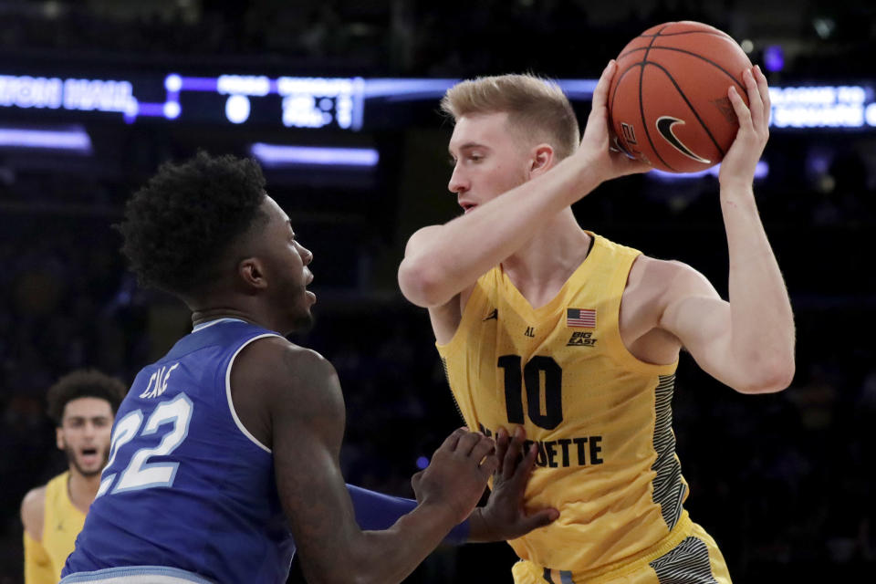 Marquette forward Sam Hauser, right, is defended by Seton Hall guard Myles Cale (22) during the first half of an NCAA college basketball semifinal game in the Big East men's tournament, Friday, March 15, 2019, in New York. (AP Photo/Julio Cortez)