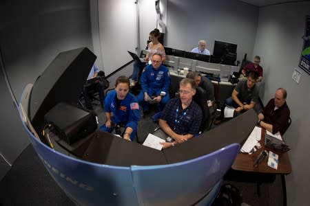 NASA commercial crew astronauts Nicole Mann and Mike Fincke and Boeing astronaut Chris Ferguson run through scenarios in a simulation cockpit of the Boeing Starliner spaceship at the Johnson Space Center in Houston