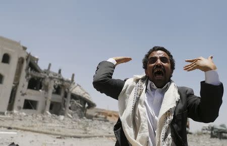 A Houthi militant reacts at the yard of the residence of the military commander of the Houthi militant group, Abdullah Yahya al Hakim, after an air strike destroyed it, in Sanaa April 28, 2015. REUTERS/Khaled Abdullah