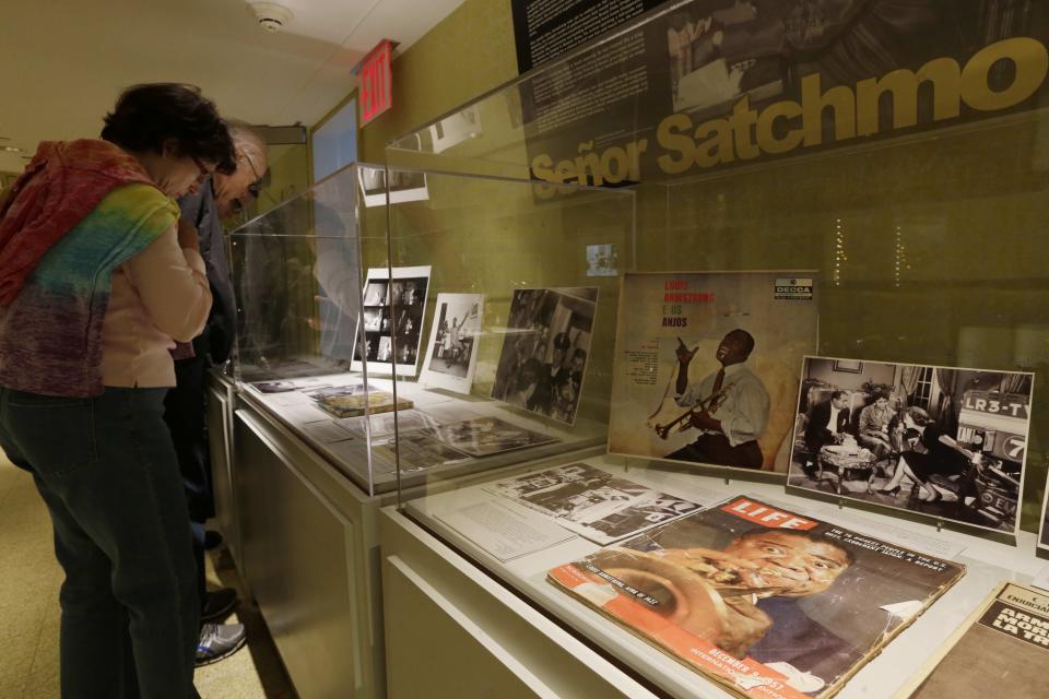 Patrons view items on display at the Louis Armstrong House Museum Wednesday, Oct. 9, 2013, in the Queens borough of New York. (AP Photo/Frank Franklin II)