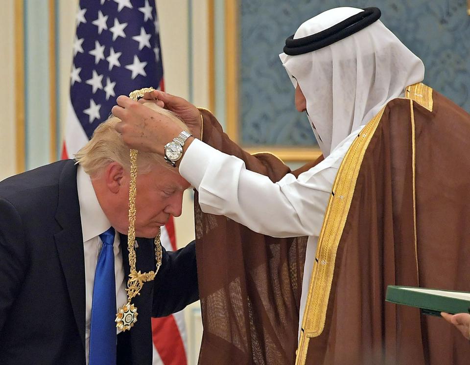 TOPSHOT - US President Donald Trump (C) receives the Order of Abdulaziz al-Saud medal from Saudi Arabia's King Salman bin Abdulaziz al-Saud (R) at the Saudi Royal Court in Riyadh on May 20, 2017.

 / AFP PHOTO / MANDEL NGANMANDEL NGAN/AFP/Getty Images ORIG FILE ID: AFP_ON1F6