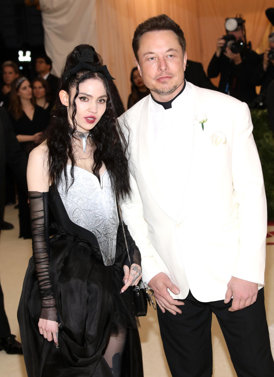 Grimes and Elon Musk in fancy black/white outfits on the red carpet