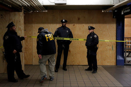 A member of the FBI enters the crime scene beneath the New York Port Authority Bus Terminal following an attempted detonation during the morning rush hour, in New York City, New York, U.S., December 11, 2017. Picture taken December 11, 2017. REUTERS/Andrew Kelly