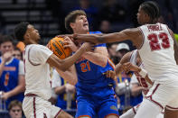 Alabama's Rylan Griffen (3) and Nick Pringle (23) try to take the ball from Florida forward Alex Condon (21) during the second half of an NCAA college basketball game at the Southeastern Conference tournament Friday, March 15, 2024, in Nashville, Tenn. (AP Photo/John Bazemore)