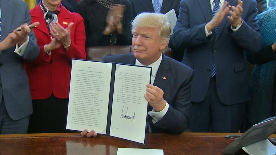U.S. President Donald Trump signs a "long overdue" reorganization of federal departments and agencies aimed at saving money and eliminating duplication.