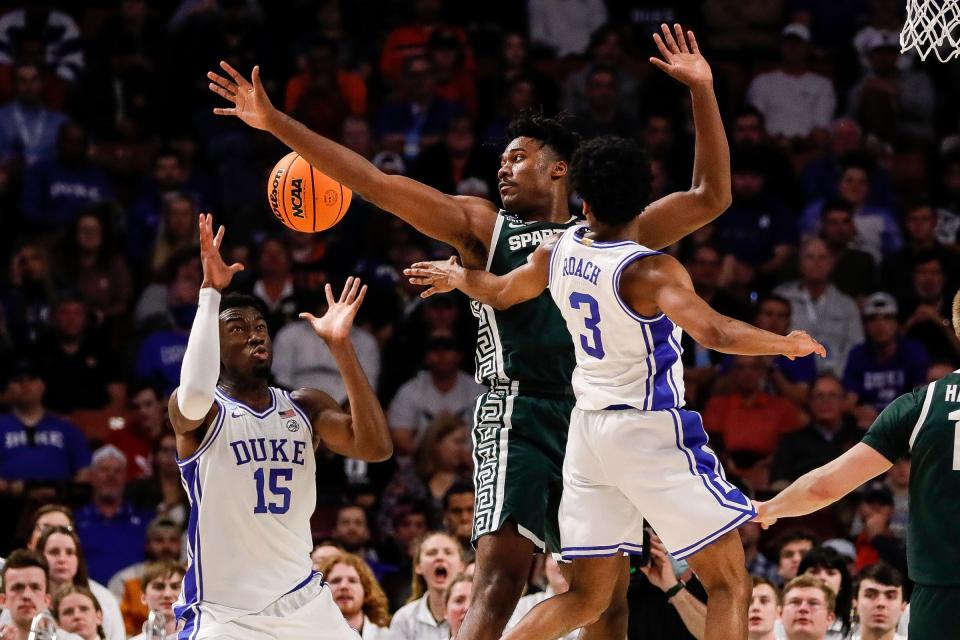 Duke guard Jeremy Roach (3) makes a pass to center Mark Williams (15) against Michigan State forward Julius Marble II (34) during the first half of the second round of the NCAA tournament at the Bon Secours Wellness Arena in Greenville, S.C..