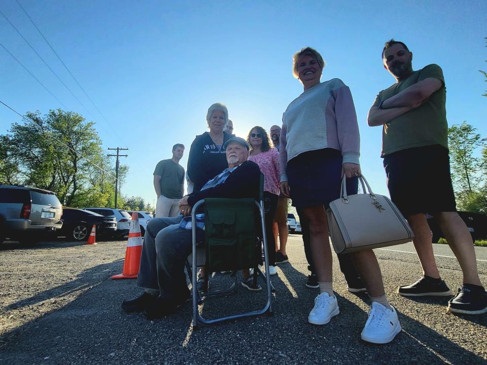 Local residents, including Kathy Kulka and son-in-law Bill Houssari, right, await entry to Club 21, where filming for a reality TV show was slated to occur, on Wednesday, May 8, 2024, in Goodells. A long line of curious participants had formed along Lapeer Road an hour or two before.