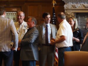  Austin Booth, director of the Arkansas Game and Fish Commission, mingles with staff before a bill signing ceremony on June 19, 2024. (Mary Hennigan/Arkansas Advocate)