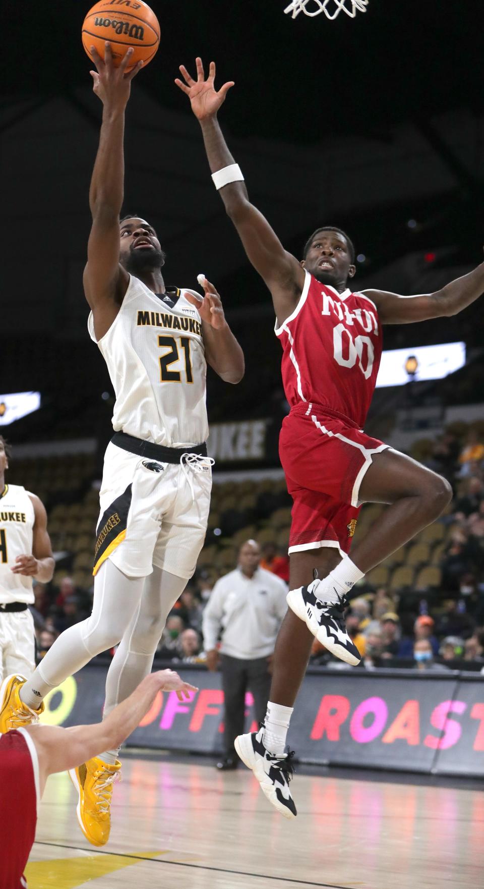 UW-Milwaukee's Tafari Simms scores against IUPUI's B.J. Maxwell during the second half.