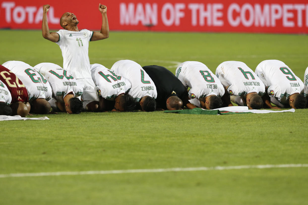 Algerian players pray after the African Cup of Nations final soccer match between Algeria and Senegal in Cairo International stadium in Cairo, Egypt, Friday, July 19, 2019. (AP Photo/Ariel Schalit)