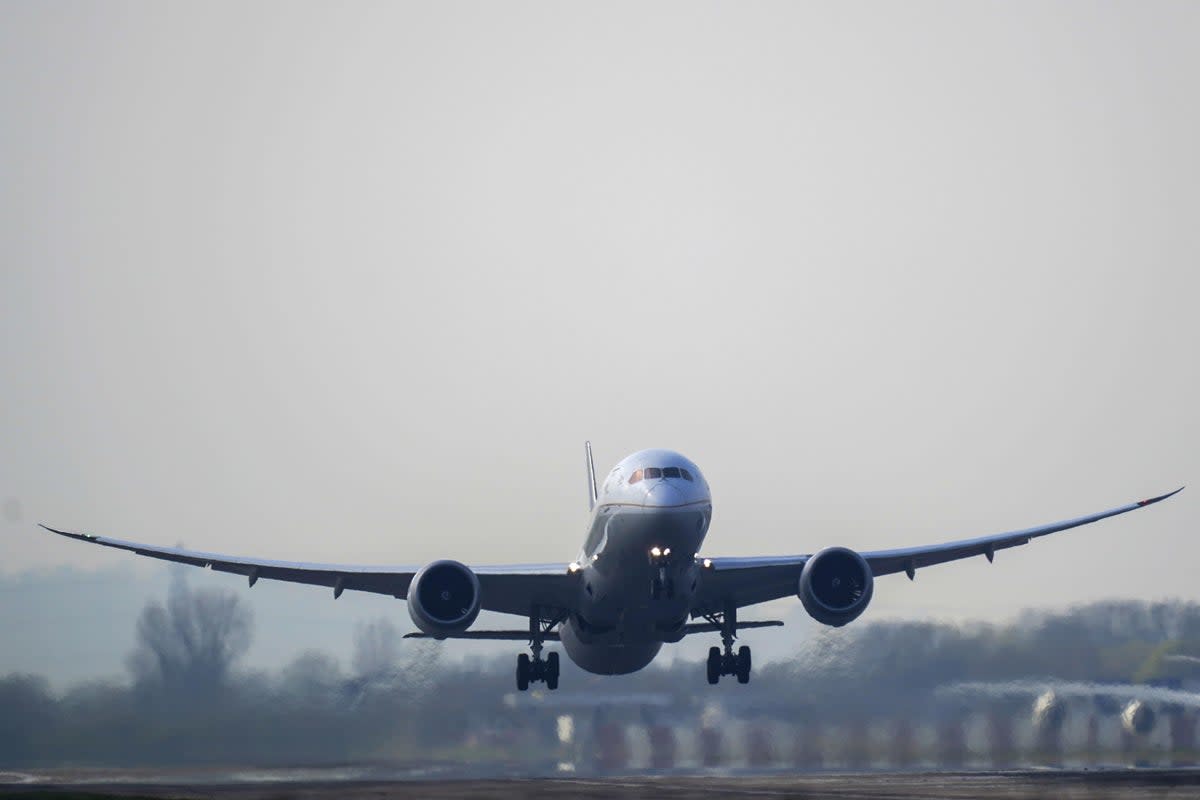 A plane lands at Heathrow Airport (PA Archive)