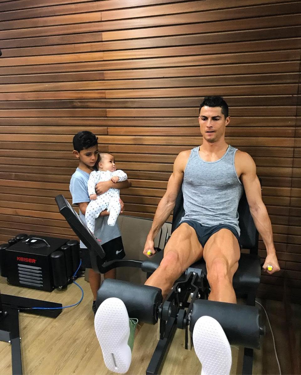 Cristiano Jr watches his dad work out in the family gym