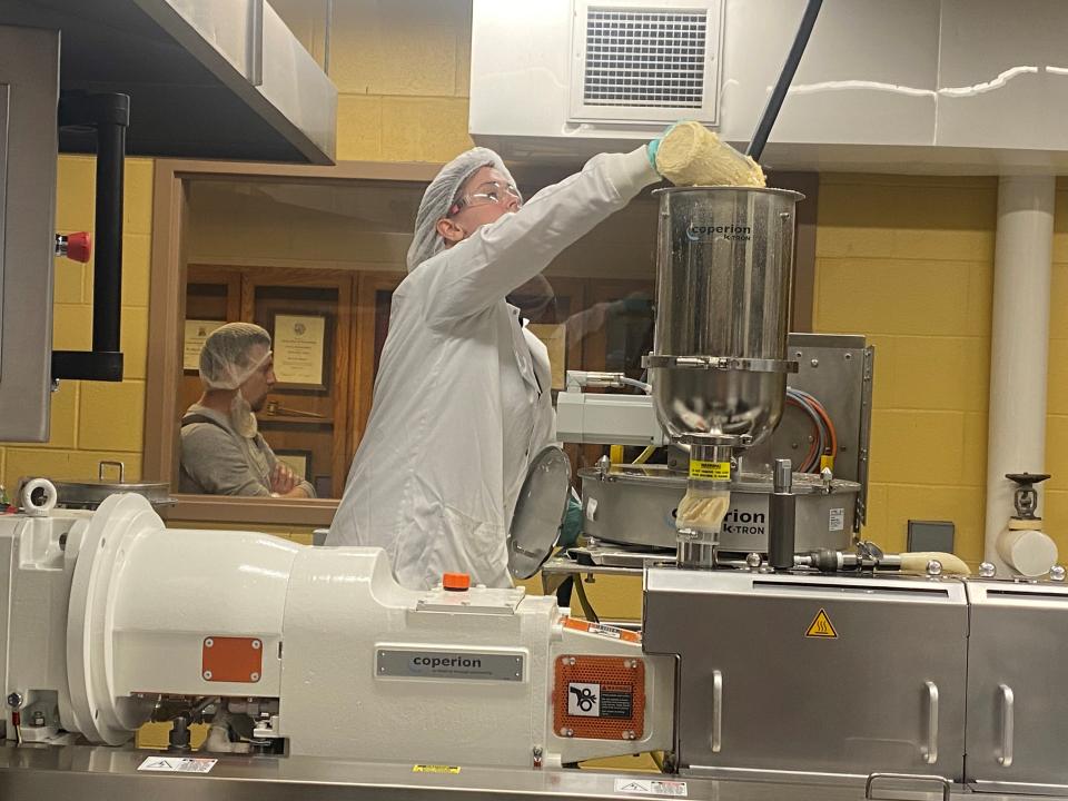 A food scientist adds materials to the extruder donated to the university by Hillenbrand and Coperion.