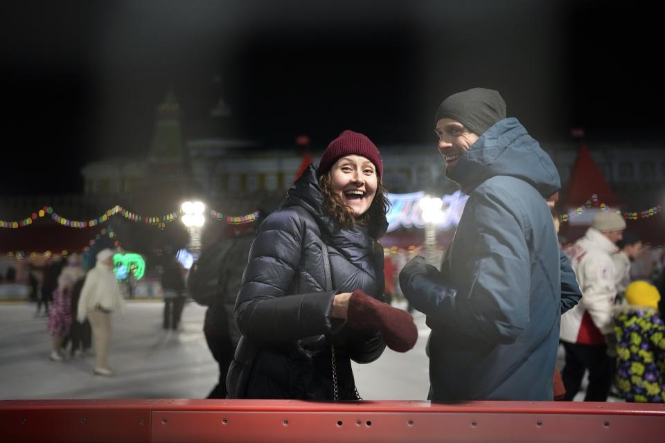 Visitors enjoy the ice rink in Red Square at the Moscow GUM State Department store with the Kremlin Wall ion the background in Moscow, Russia, late Monday, Feb. 14, 2022. While the U.S. warns that Russia could invade Ukraine any day, the drumbeat of war is all but unheard in Moscow, where political experts and ordinary people alike don't expect President Vladimir Putin to launch an attack on the ex-Soviet neighbor. (AP Photo/Alexander Zemlianichenko)