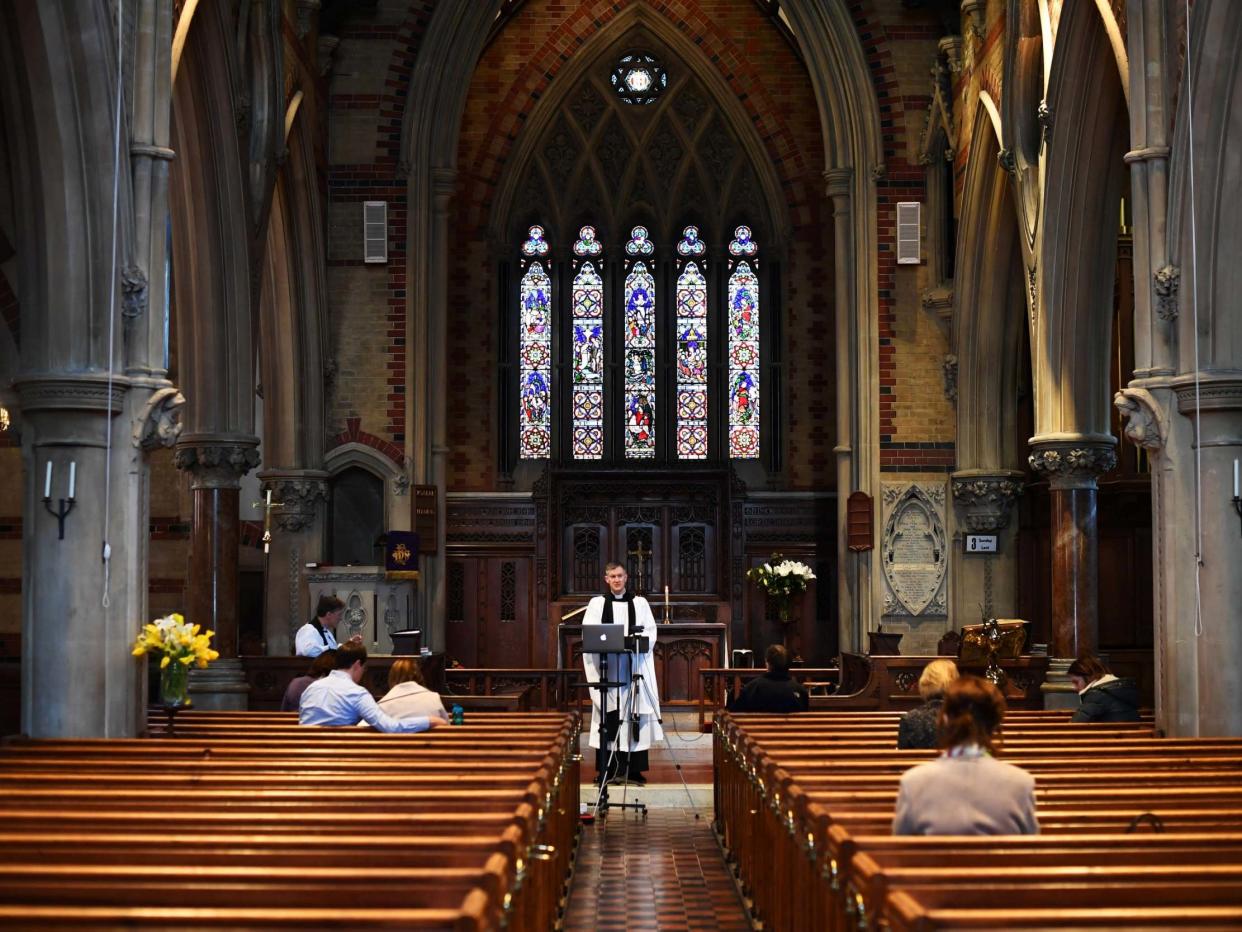 Curate Philip Stewart delivers his service via live stream and to a small congregation at Saint Simon Zelotes in London before the church closed its doors on Sunday night: REUTERS