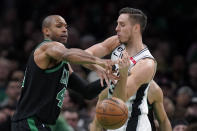 Boston Celtics center Al Horford, left, and San Antonio Spurs forward Zach Collins, right, vie for control of the ball in the first half of an NBA basketball game, Sunday, March 26, 2023, in Boston. (AP Photo/Steven Senne)