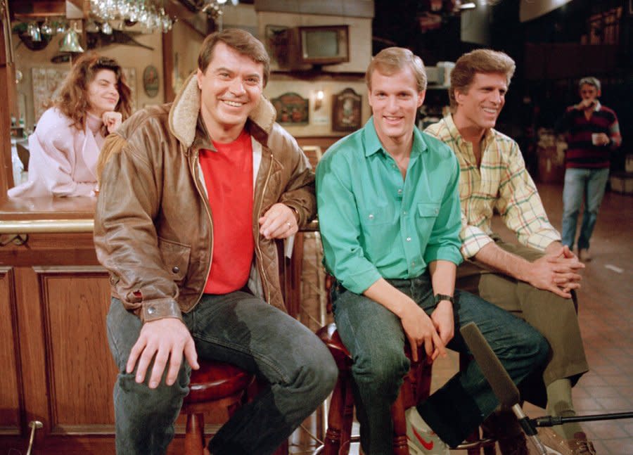 Robert Urich, second from left, star of the television series “Spencer For Hire,” visits with “Cheers” cast members, left to right, Kirstie Alley, Woody Harrelson and Ted Danson, Nov. 23, 1987. (AP Photo/Mark Terrill)