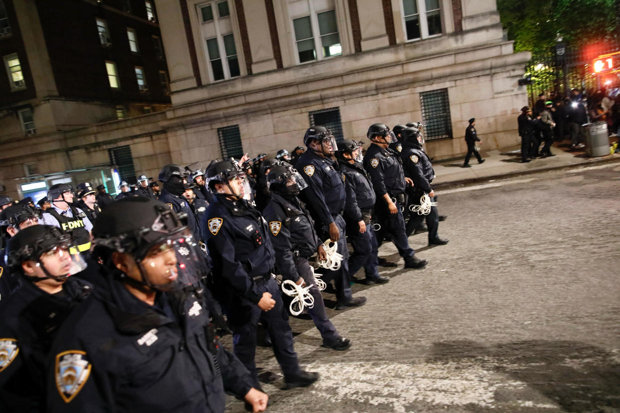 NYPD officers in riot gear march onto Columbia University campus, where pro-Palestinian students are barricaded inside a building and have set up an encampment, in New York City on April 30, 2024. / Credit: KENA BETANCUR/AFP via Getty Images