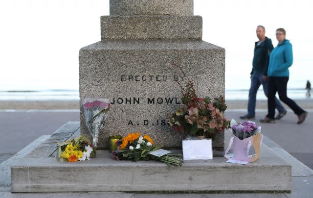 Floral tributes for Gaia Pope are left at the King Alfred Monument on the seafront in Swanage