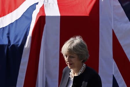 Britain's Prime Minister Theresa May waits to address sailors on deck of HMS Ocean in Manama, Bahrain December 6, 2016. REUTERS/Stefan Wermuth