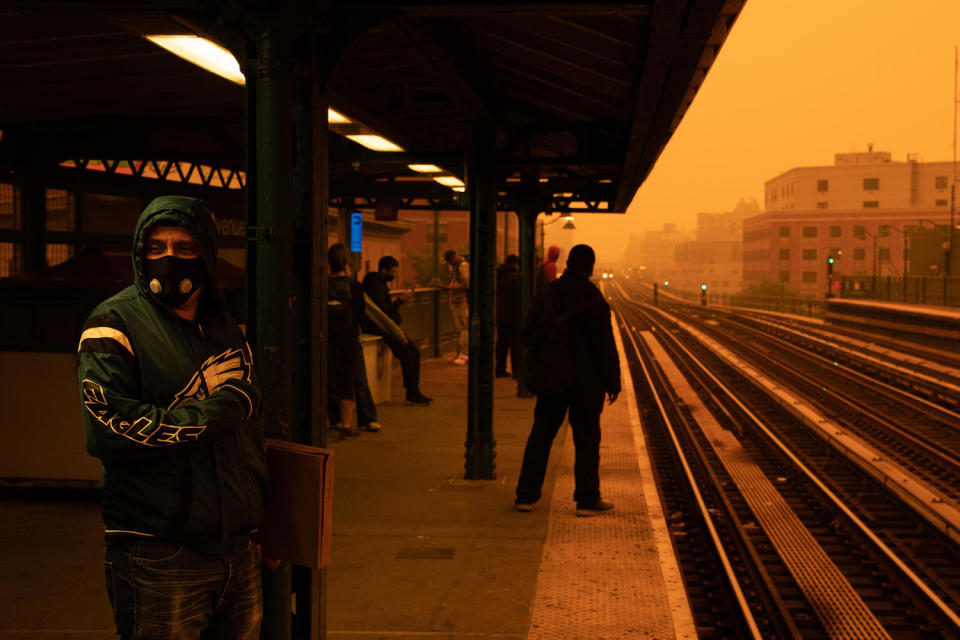 A person waiting for the subway wears a filtered mask as smoky haze from wildfires in Canada blankets a neighborhood.  (David Dee Delgado / Getty Images file.)