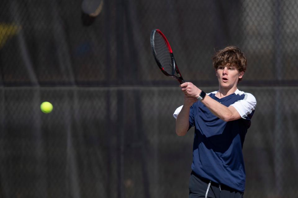 Hayden Tyler Broxterman returns the ball April 2 at Kossover Tennis Court in Topeka.