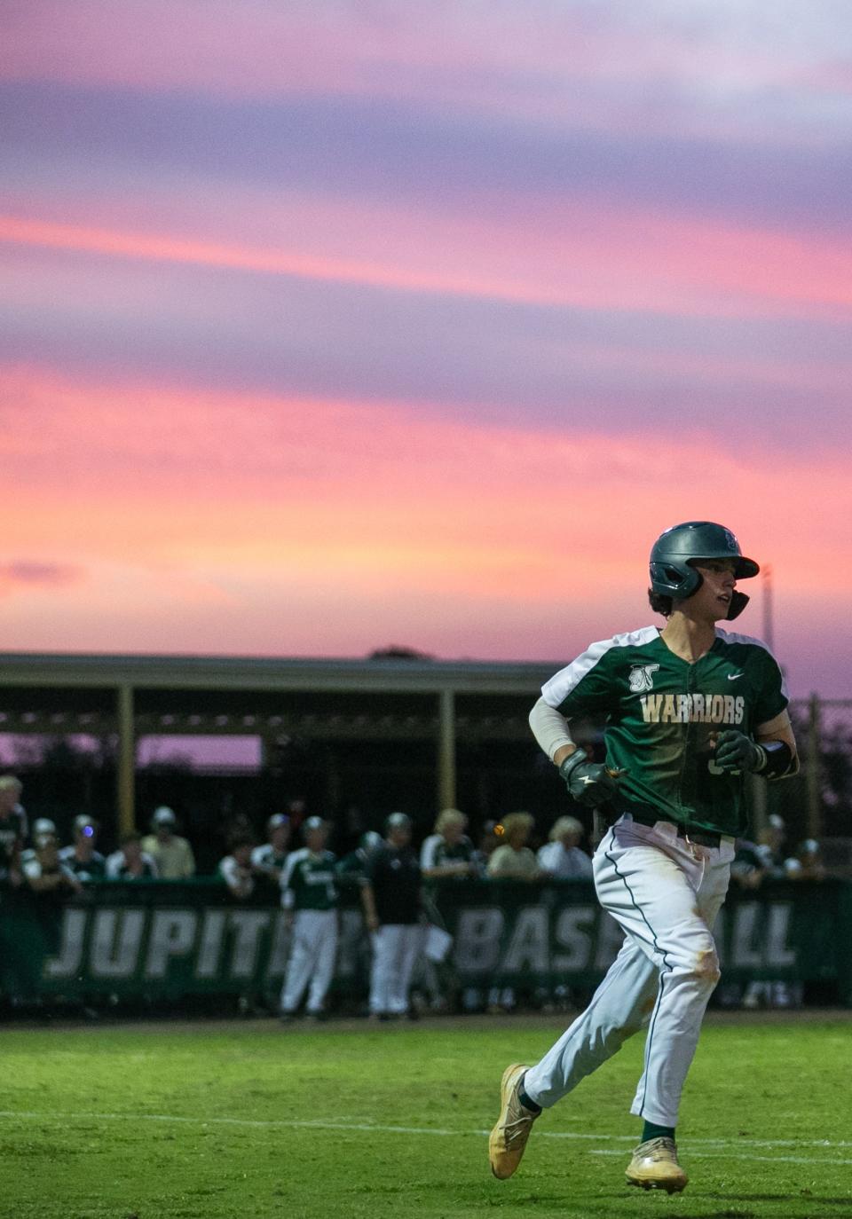 Jupiter third baseman Jake Finnegan (30) runs to first base during the District 11-7A championship baseball game between host Jupiter and Palm Beach Central on Thursday, May 4, 2023, in Jupiter, Fla. Final score, Jupiter, 11, Palm Beach Central, 3.