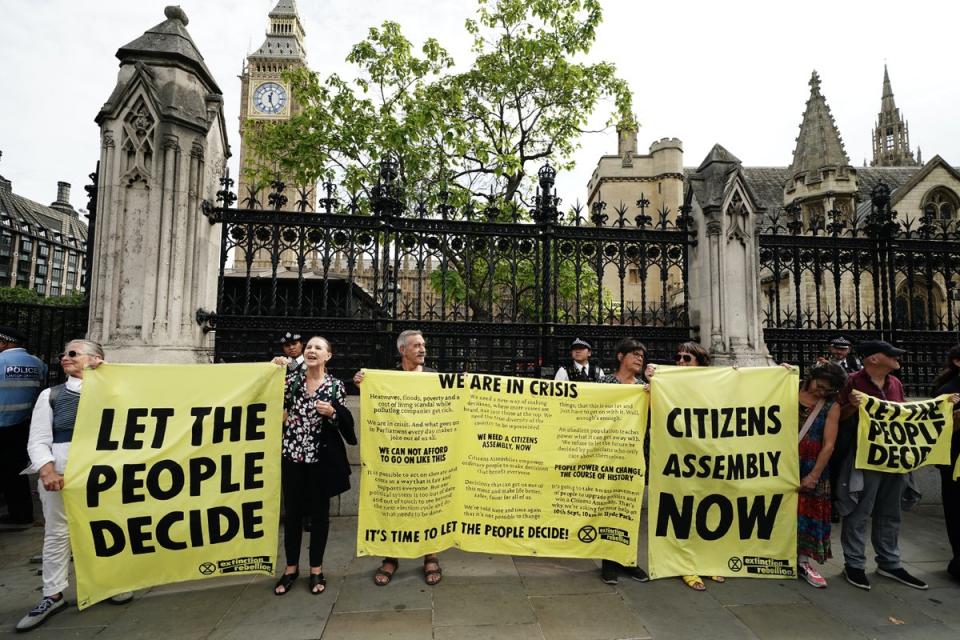 Extinction Rebellion protesters outside the Houses of Parliament, calling for a citizens’ assembly (Aaron Chown/PA) (PA Wire)