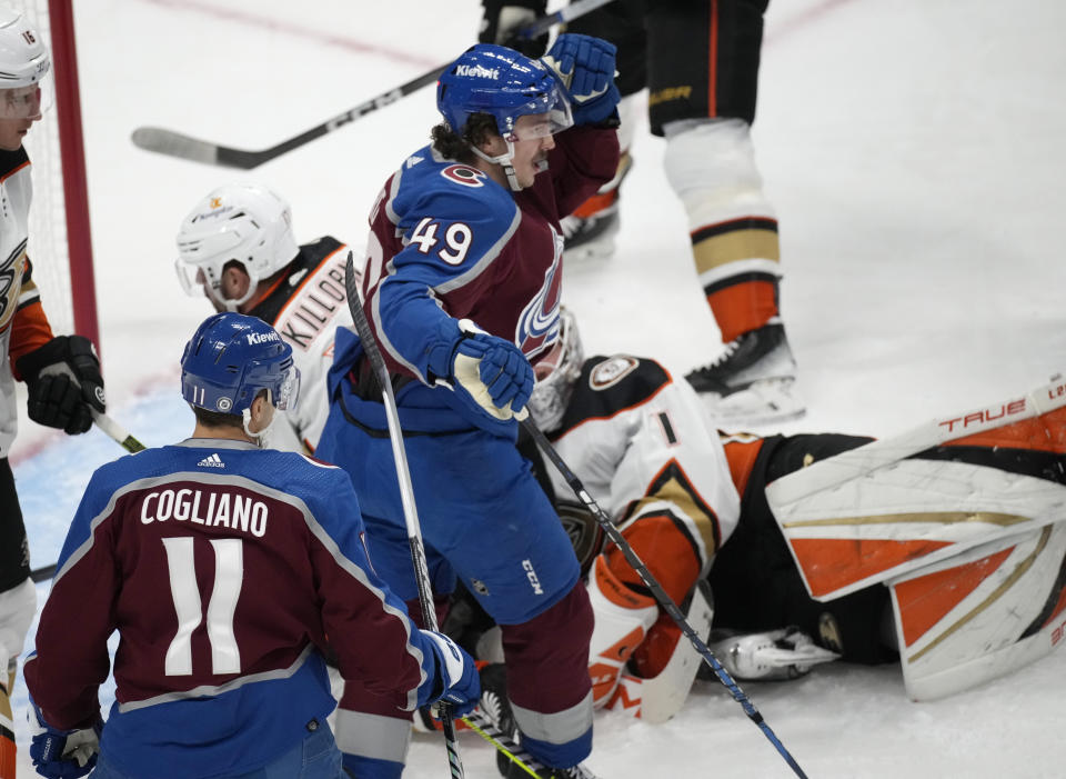 Colorado Avalanche defenseman Samuel Girard, center, celebrates after scoring a goal with center Andrew Cogliano, front, as Anaheim Ducks goaltender Lukas Dostal drops to the ice in the first period of an NHL hockey game Wednesday, Nov. 15, 2023, in Denver. (AP Photo/David Zalubowski)