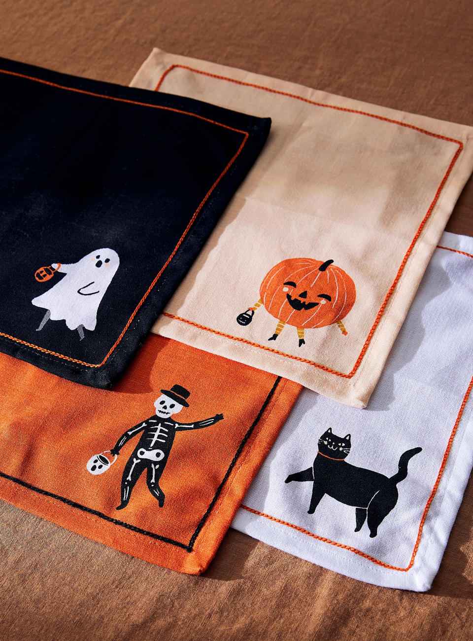 four halloween napkins overlapping each other on a table