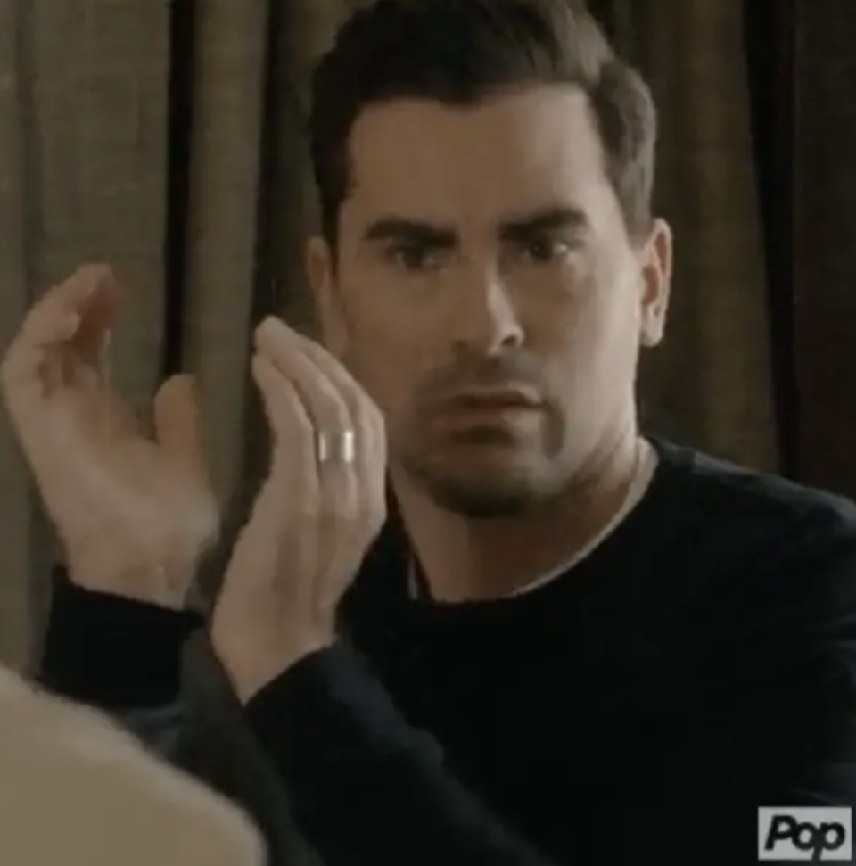 David from Schitt's Creek clapping but looking concerned