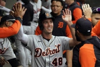 Detroit Tigers' Kerry Carpenter (48) is greeted in the dugout after scoring against the Chicago White Sox during the eighth inning of a baseball game, Sunday, Sept. 25, 2022, in Chicago. (AP Photo/David Banks)