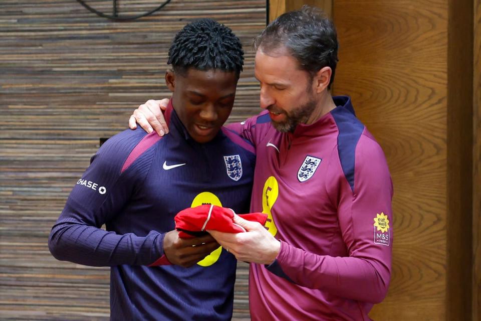 Mainoo is presented with his first England cap after appearing against Brazil (The FA/Getty)