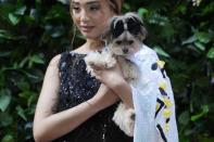 A dog and model attend the Pet Gala fashion show at AKC Museum of The Dog, Monday, May 20, 2024, in New York. (Photo by Charles Sykes/Invision/AP)