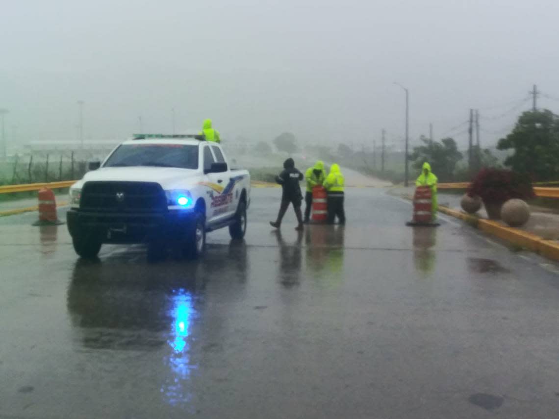 Authorities stand behind a flooded roadway in the Puerto Rican town of Gurabo as Hurricane Fiona impacted the island on Sunday, Sept. 18, 2022.