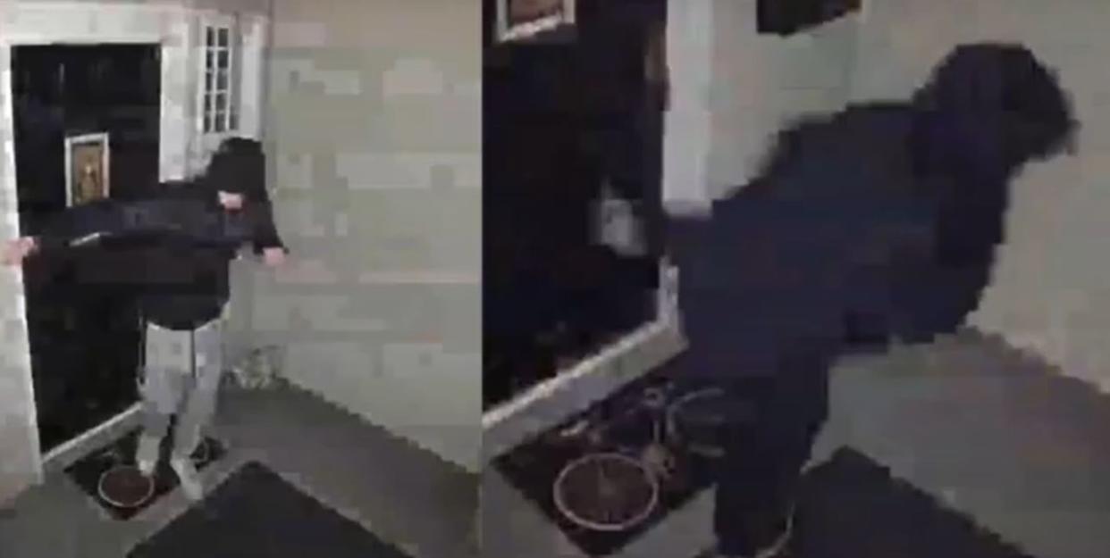 RCMP say a screengrab from CCTV video shows two suspects kicking the door of a North Vancouver home in the early hours of Feb. 17. Police are searching for two suspects in what they describe as an ongoing case of harassment.  (North Vancouver RCMP - image credit)