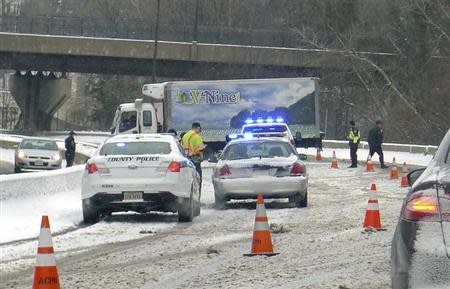 A truck blocks a traffic on an accident on route 66 in Arlington, Virginia March 3, 2014. REUTERS/Yuri Gripas